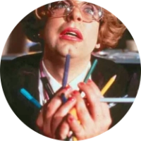 Steve Pemberton is in the character of the eponymous Pauline, holding pens up with zeal, from the League of Gentleman TV show