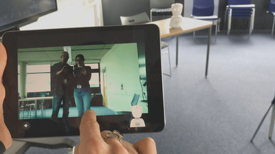The robot in a classroom being controlled using an iPad.