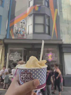 An gelato in a tub with a spoon held up in front of the Boho Gelato shop front in the Poole Valley, Brighton